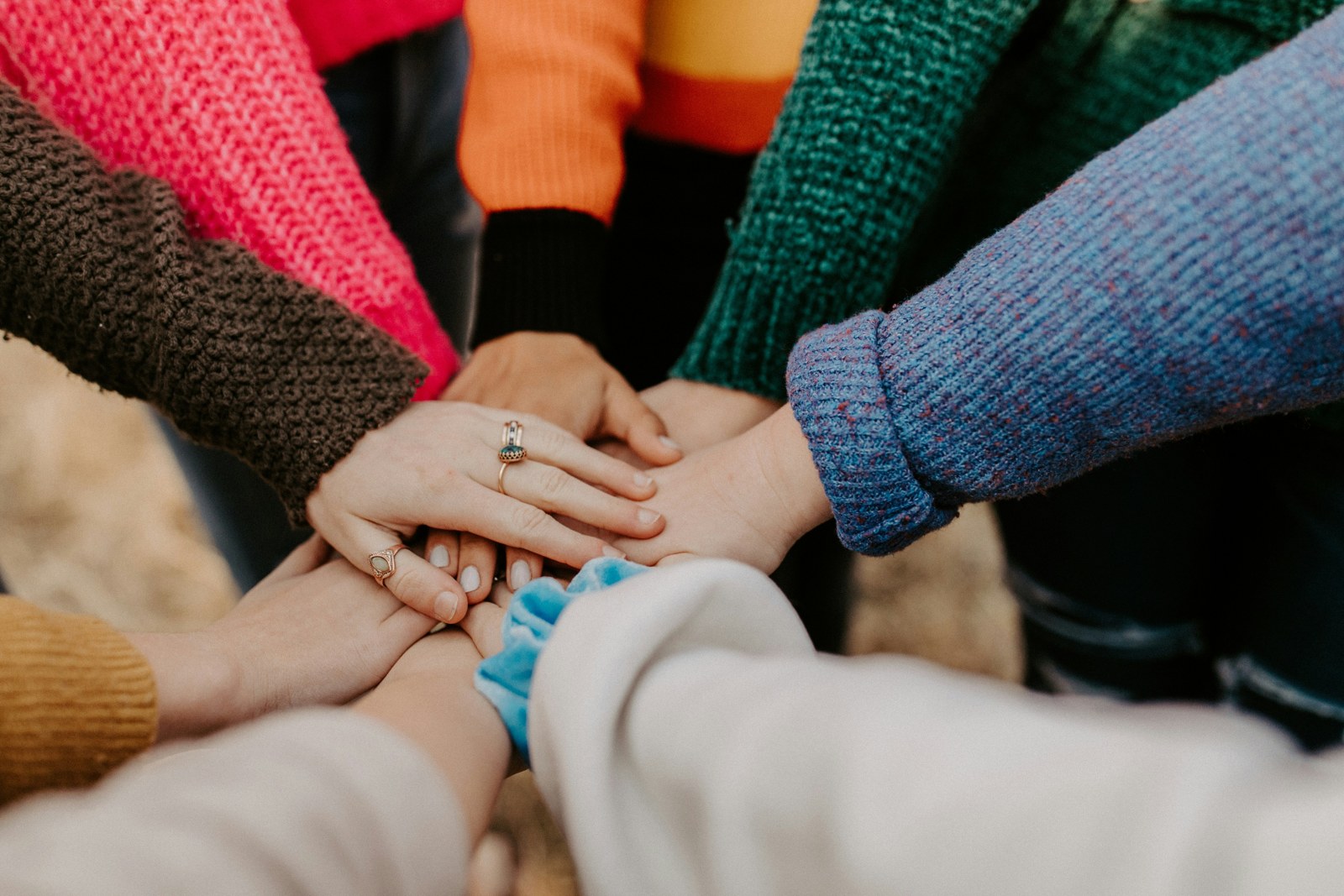 People bringing their hands together in a gesture of community