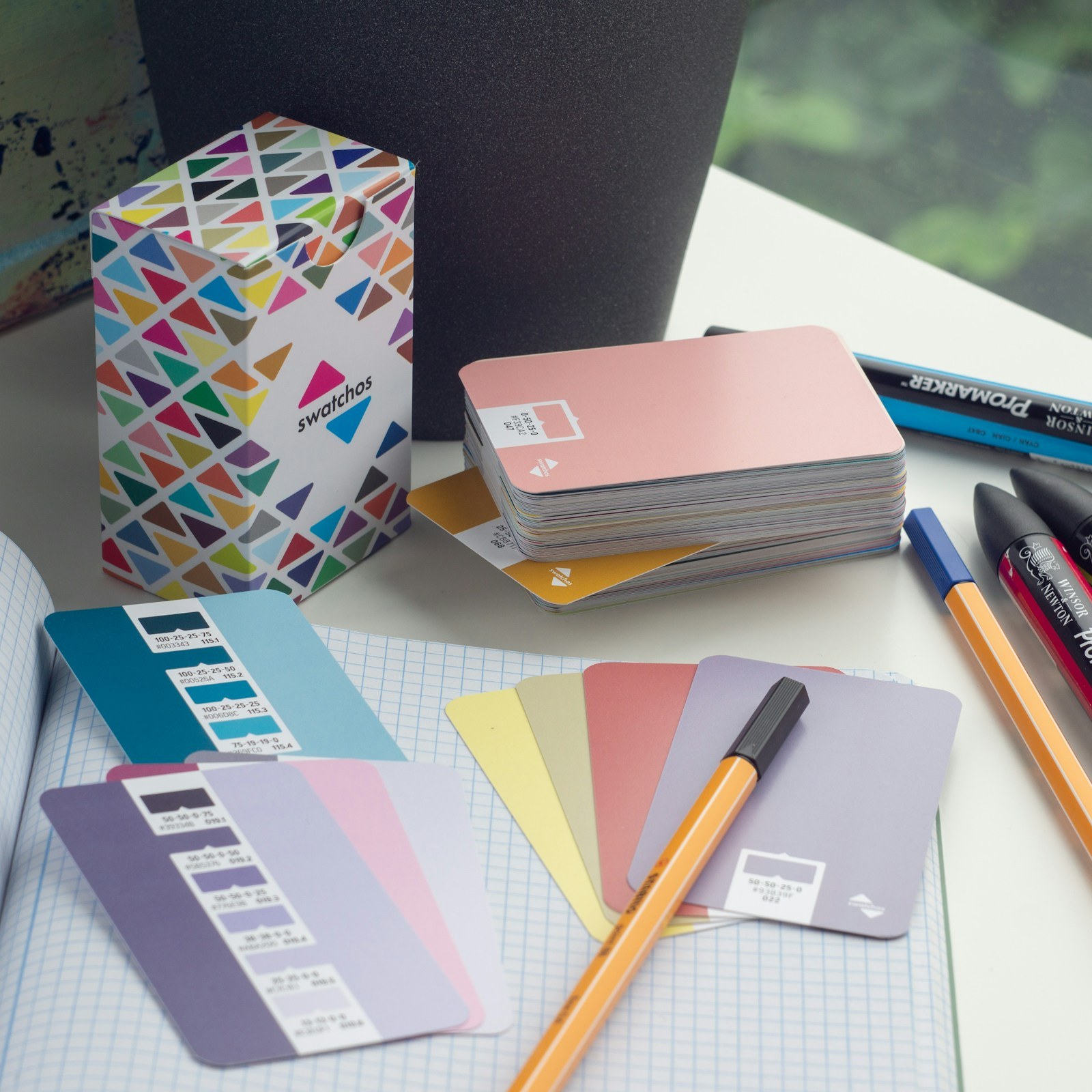 Illustrative creative planning desk with color swatches and notebooks